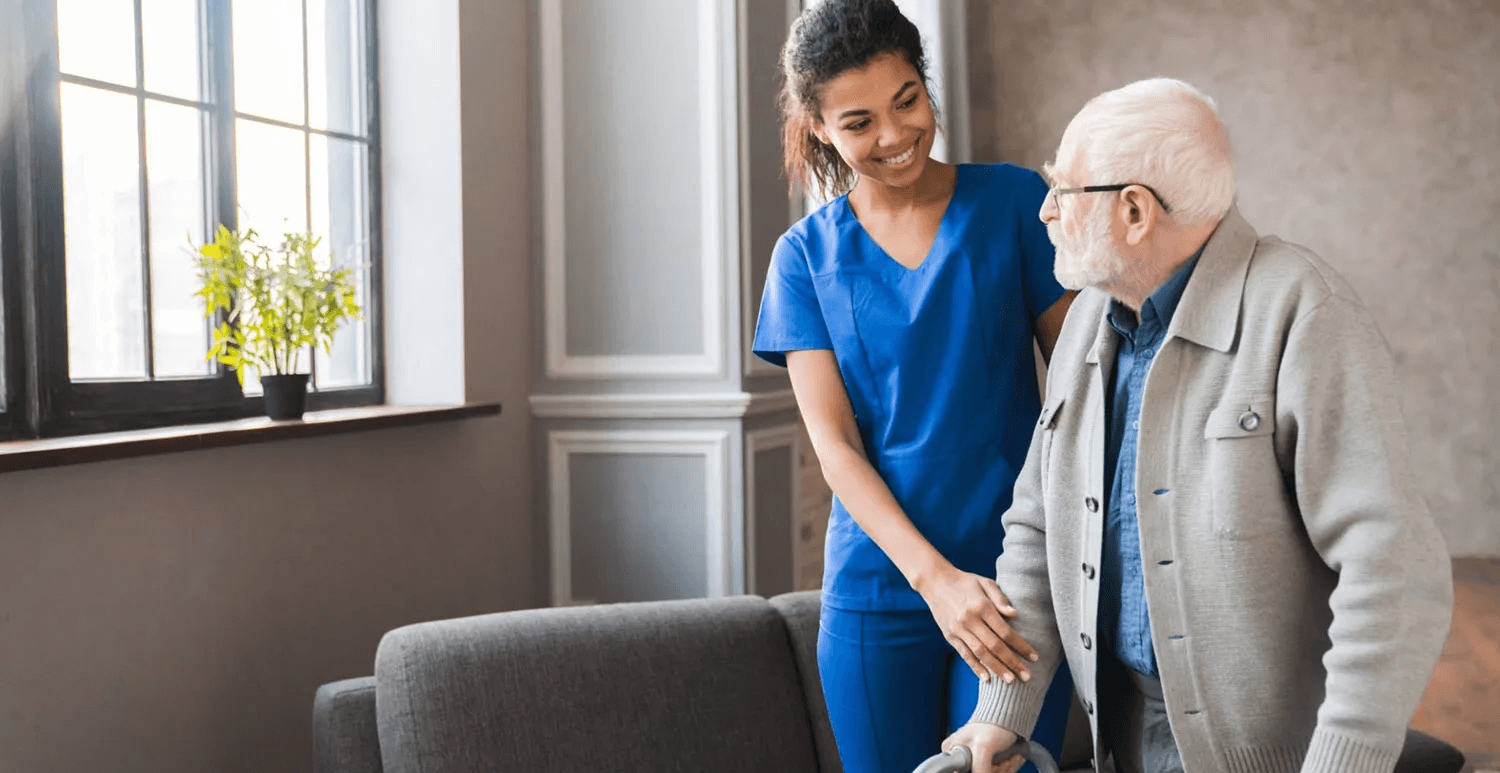 A carer supporting an older man at home
